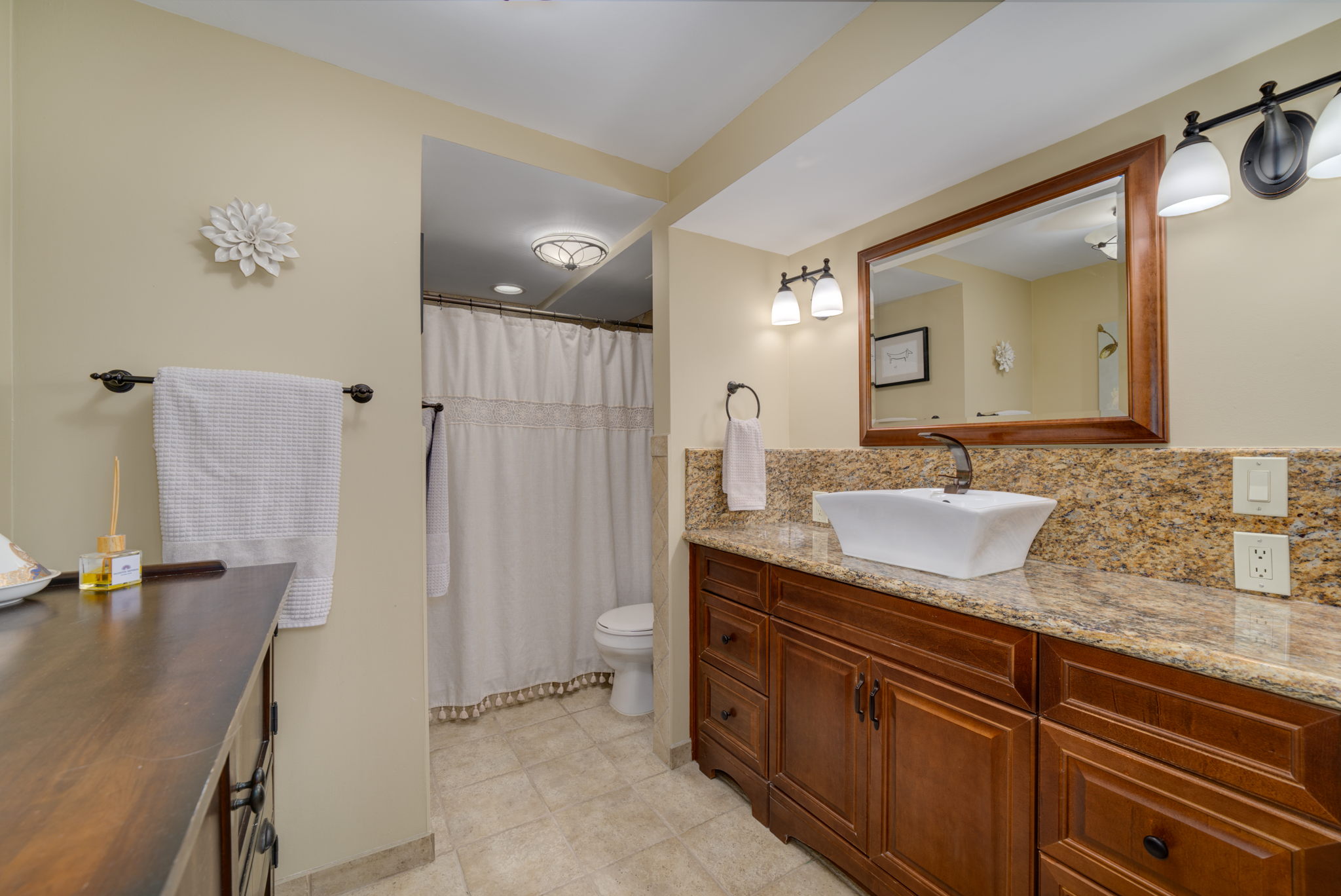 The main floor bathroom is exceptionally spacious and features a large tiled shower, wide vanity with granite counter. Isn't this lovely? This could be a spa bathroom!