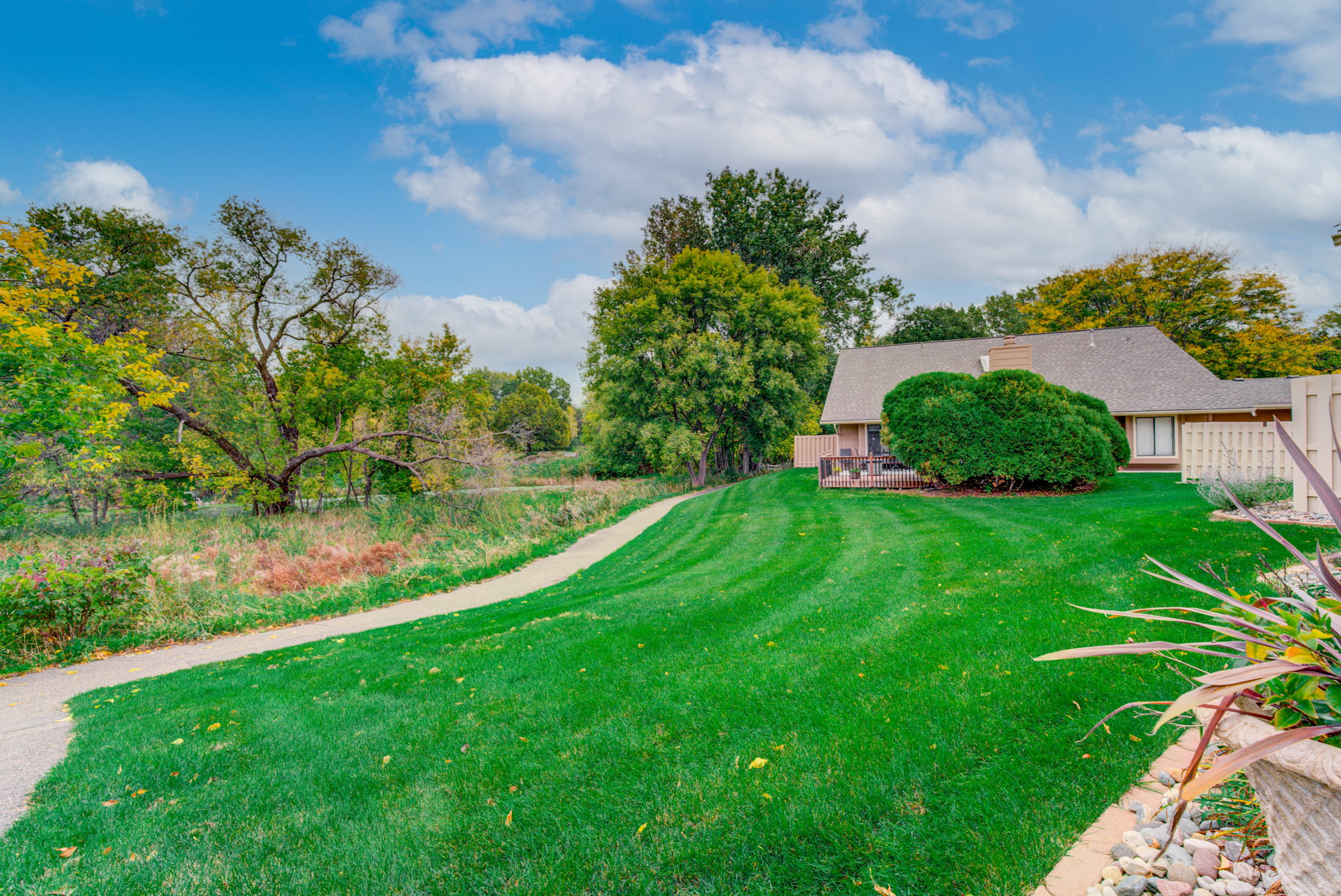 This is the yard behind the townhome. Such a great location. The walking path leads to Medley park and also connects to the General Mills Research Nature Area path.