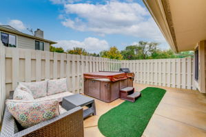 Oh my! Fenced patio with hot tub and putting green.