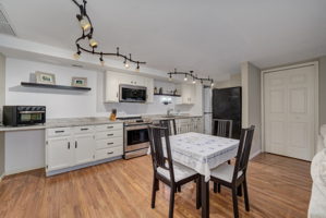 Second view of the kitchen shows a glimpse of the stackable washer and dryer.