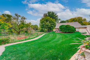 This is the yard behind the townhome. Such a great location. The walking path leads to Medley park and also connects to the General Mills Research Nature Area path.