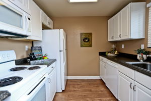 Kitchen with refrigerator, range, microwave